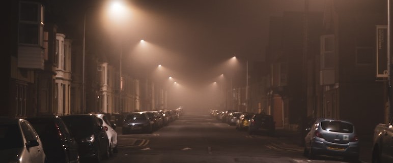 cars parked on side of the road during night time